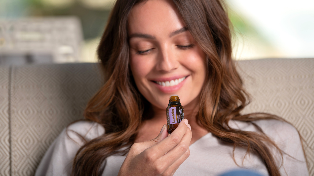 Young Women Holding A Small Bottle of Essential Oil